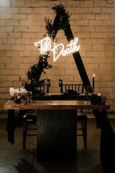 the table is set up with candles and greenery