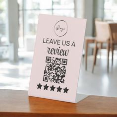 there is a sign that says leave us a review on the table in front of some chairs