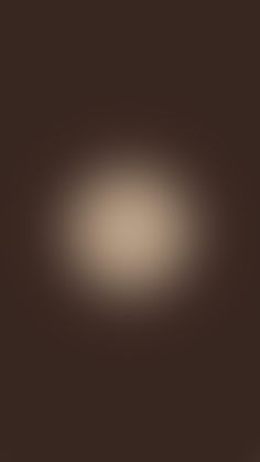 a blurry image of a dark brown background