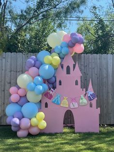 a castle made out of balloons in the yard