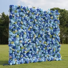 a large blue flowered wall in the middle of a field