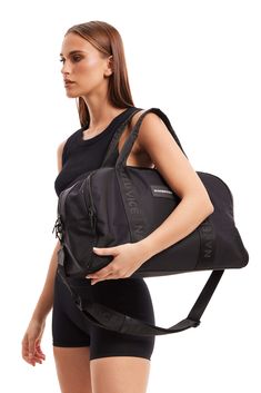 The Tobi by Nakedvice is a unisex duffle bag crafted from smooth black nylon. Featuring matte black hardware and a minimal black and white Nakedvice logo. The Tobi sports two top handles and a removable Nakedvice branded strap allowing you to carry The Tobi by hand or wear it as a crossbody bag. The Tobi opens up to a spacious interior with plenty of room to store your travel essentials. We designed The Tobi so. that it can be used as an overnight bag, gym bag, baby bag or travel bag.

This prod Matte Black Hardware, Overnight Bag, Black Nylon, Black Hardware, Black Nylons, Baby Bag, Travel Essentials, Travel Bag, Gym Bag