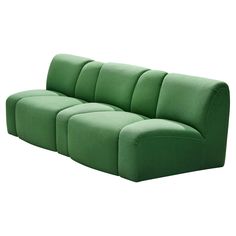 a green couch sitting on top of a white floor