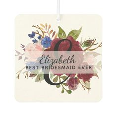 the personalized floral wedding gift tag is hanging from a string with an initial on it