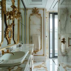 a bathroom with marble counter tops and gold trimming on the walls, along with a walk in shower