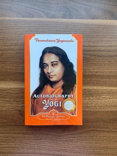 an orange book sitting on top of a wooden table