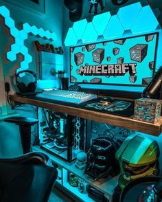 a computer desk with a keyboard, mouse and headphones on it in front of a minecraft poster