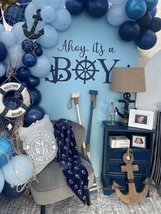 there is a blue and white balloon display with an anchor on the wall next to it