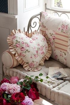 a couch with pillows and flowers on it