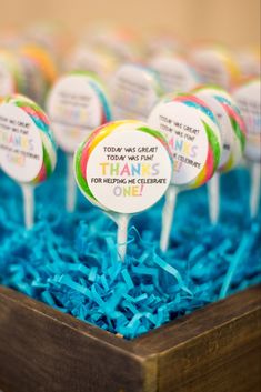 there are many candy lollipops on top of the blue carpeted tray