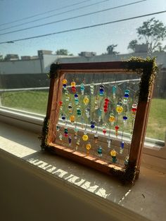 a window sill filled with lots of colorful glass beads on it's side