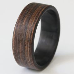 a wooden ring is shown on a white surface