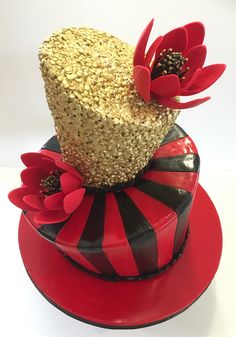 a red and black cake with flowers on top