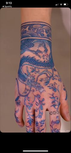 a person's hand with tattoos on it