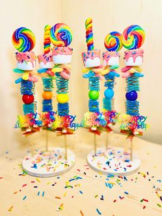 two candy lollipops on sticks with sprinkles