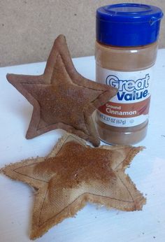 a star shaped cookie next to a jar of cinnamon sugar