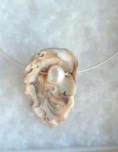 a necklace with a white pearl in the center