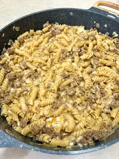 a skillet filled with pasta and ground beef