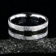 9mm wide men's wedding band with a dark dinosaur bone center inlay, Gibeon meteorite edges, and a flat profile The Woodsman, Dinosaur Bone Ring, Fossil Ring, Gibeon Meteorite, Bone Ring, Meteorite Ring, Dinosaur Bones, Bone Inlay, Ring Stand