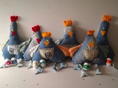 several stuffed chickens are lined up against a wall