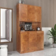 a large wooden cabinet sitting next to a mirror on top of a wall in a living room