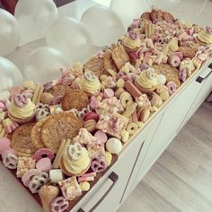 a table topped with lots of different types of cookies and pastries on top of it