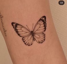 a small butterfly tattoo on the ankle is shown in black and white, with words written below it