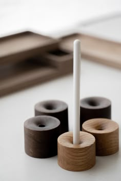 three rolls of toilet paper sitting on top of a white table next to a brush