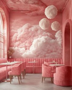 a pink restaurant with clouds painted on the wall