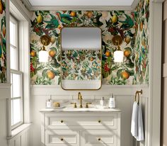 a bathroom with wallpaper, sink and mirror