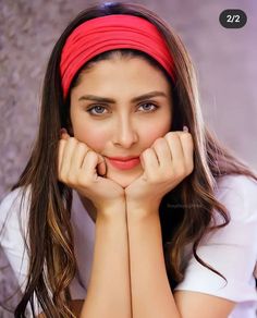 a woman with long hair wearing a red headband