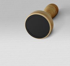 a wooden wine bottle stopper with a black top