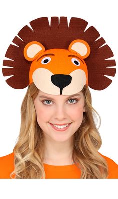 a girl wearing an orange shirt and a brown hat with a lion head on it