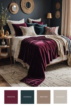 a bedroom with dark blue walls, white bedding and maroon blankets on the bed