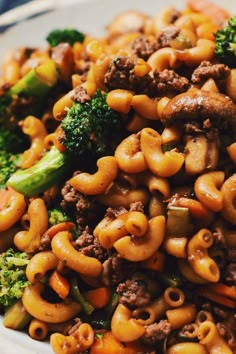 a close up of a plate of food with broccoli and macaroni