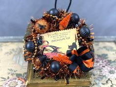 a halloween wreath with black and orange decorations