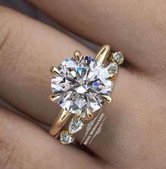 a woman's hand with a ring on it and a diamond in the middle