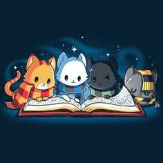 three cats are sitting on an open book