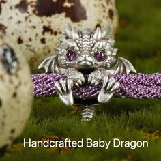 Introducing our enchanting Handcrafted Sterling Silver Baby Dragon Bracelet.Crafted with exquisite attention to detail, this bracelet features a charming baby dragon, symbolizing the untamed spirit and boundless potential within us all. The intricate design captures the dragon's fierce yet endearing essence, with delicate scales, intricate wings, and captivating sapphire-blue eyes that gleam with a sense of wonder and adventure. Choose from red, blue, or turquoise light teal eyes colors with cor Teal Eyes, Dragon Bracelet, Silver Dragon, Cute Dragons, Baby Dragon, Kids Birthday Gifts, Black Dragon, Purple Eyes, Light Teal