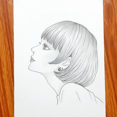 a drawing of a woman's profile with short hair and bangs on her head