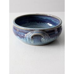 a blue bowl sitting on top of a white table