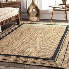 a living room with a couch and rugs on the floor