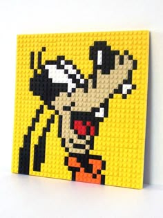 an image of a cartoon character made out of legos on a white surface with yellow background