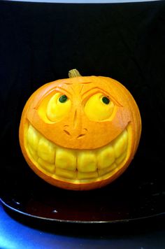 a carved pumpkin with an evil smile on it's face