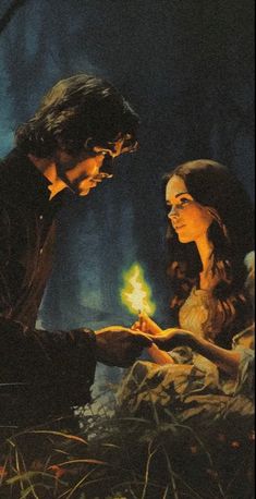 the young man and woman are lighting candles together