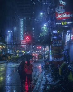 two people walking down the street in the rain at night with an umbrella over their head