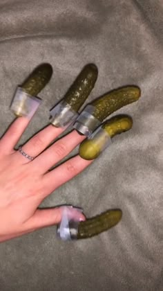 the fingers are covered with fake cucumbers