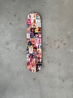 a skateboard covered in photos is laying on the ground