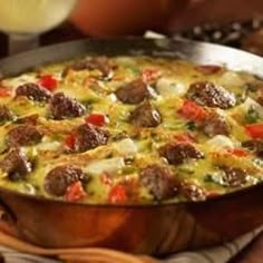 a large metal pan filled with food on top of a table