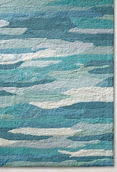 a rug with blue and white waves on it